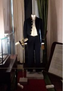 The dressing room contains a full suit worn by Dickens, yet the empty standing suit underscores how the house is now a museum rather than a current residence. 